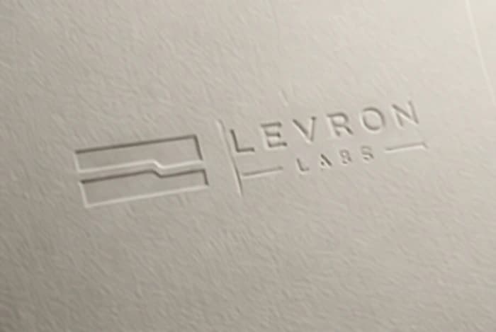 The Levron Labs mark blind-embossed into paper stock